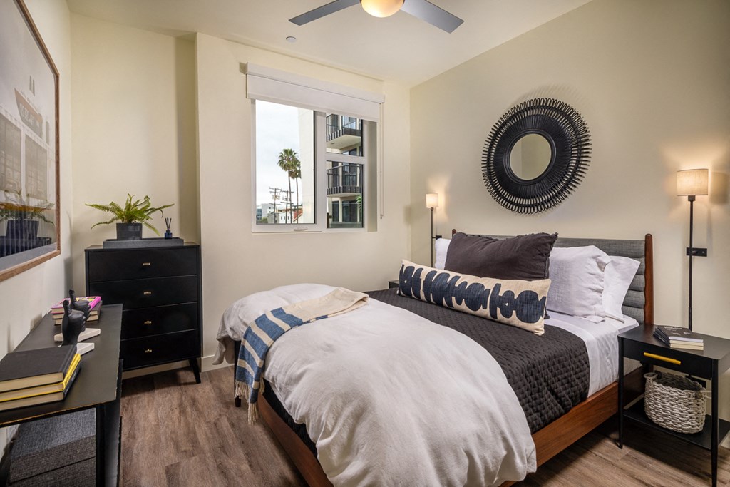 a bedroom with a large bed and a ceiling fan