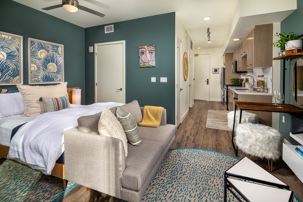 a bedroom and living room with a couch and a bed