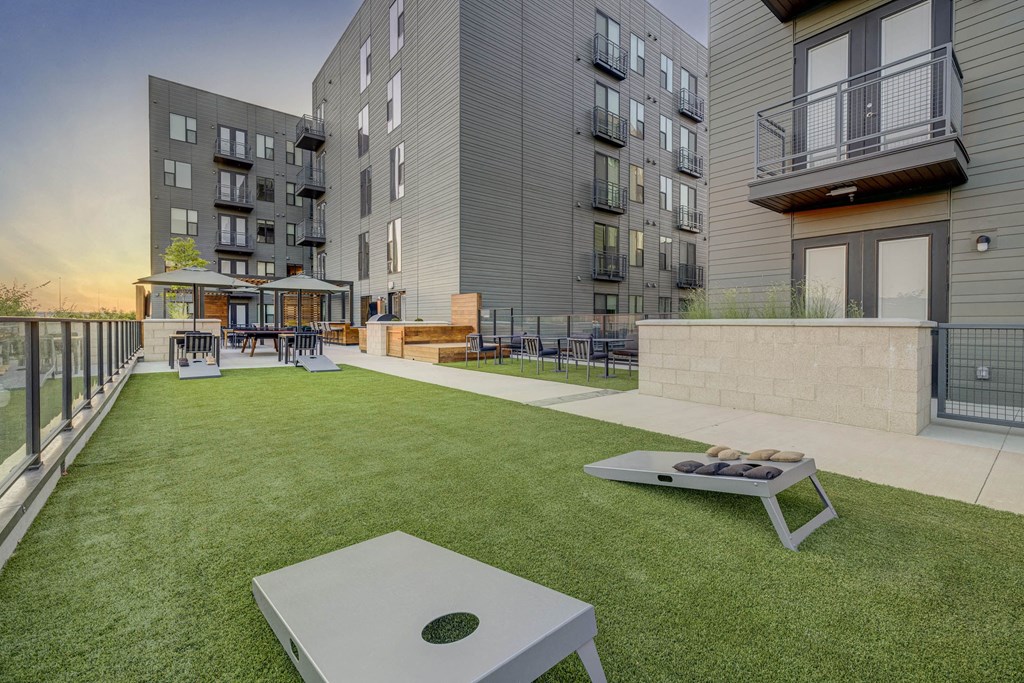 an apartment patio with a table and a fire pit
