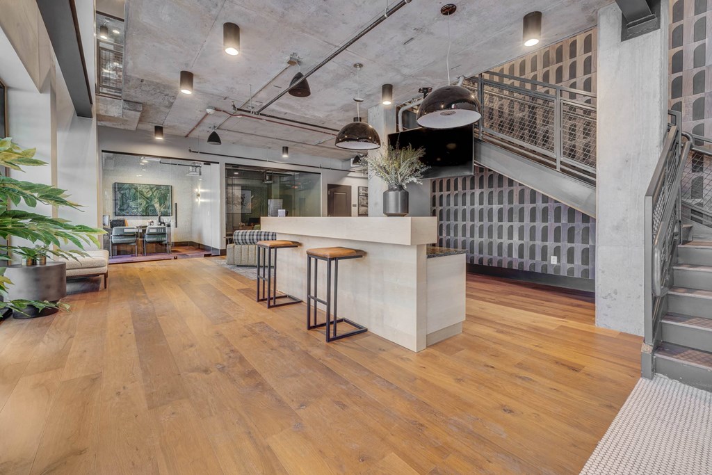 the lobby of a building with a reception desk and a staircase