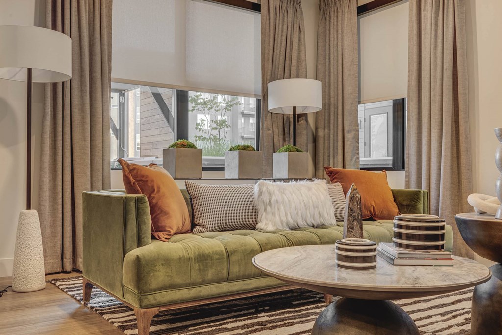 a living room with a green couch and a table
