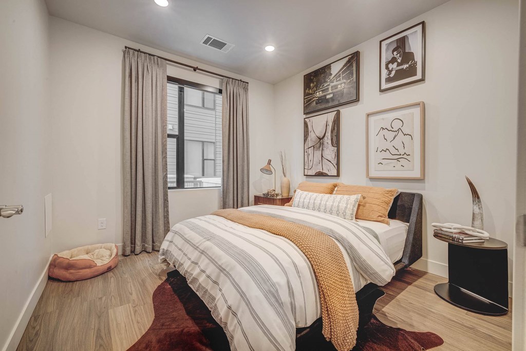 a bedroom with a bed and a window