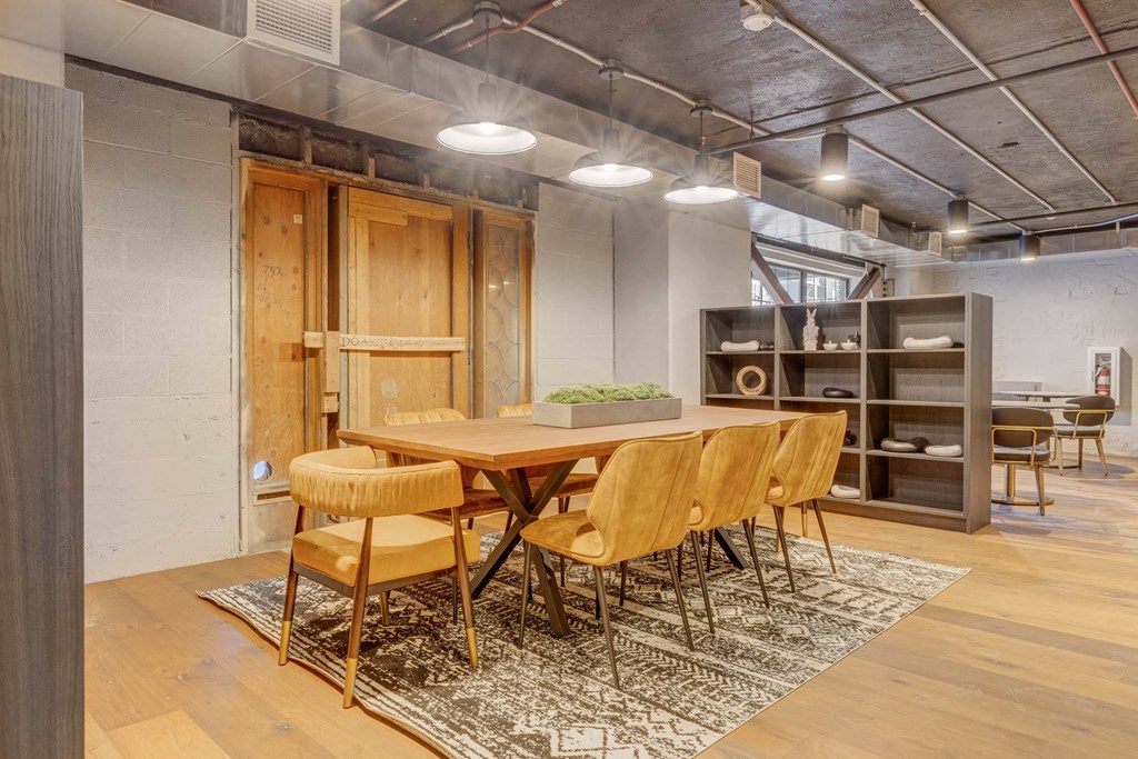 a dining room with a wooden table and chairs