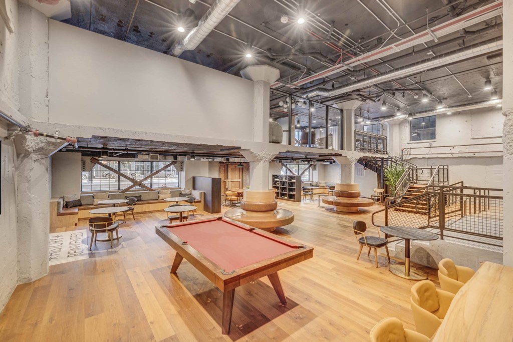 a game room with a red pool table