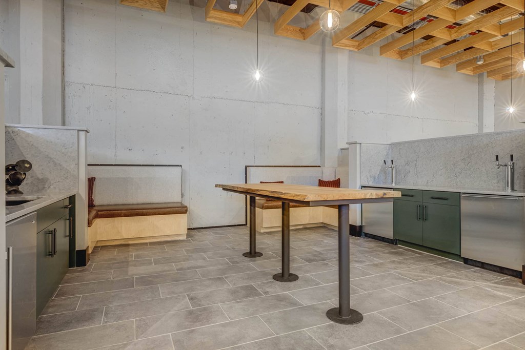 a kitchen with stainless steel appliances and a wooden table