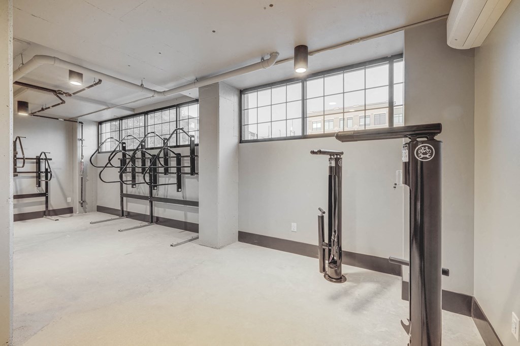 the interior of a building with white walls and gym equipment