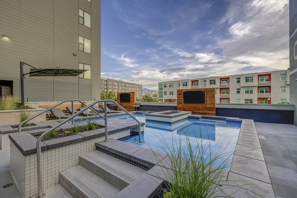 apartments with a pool and stairs in front of a building
