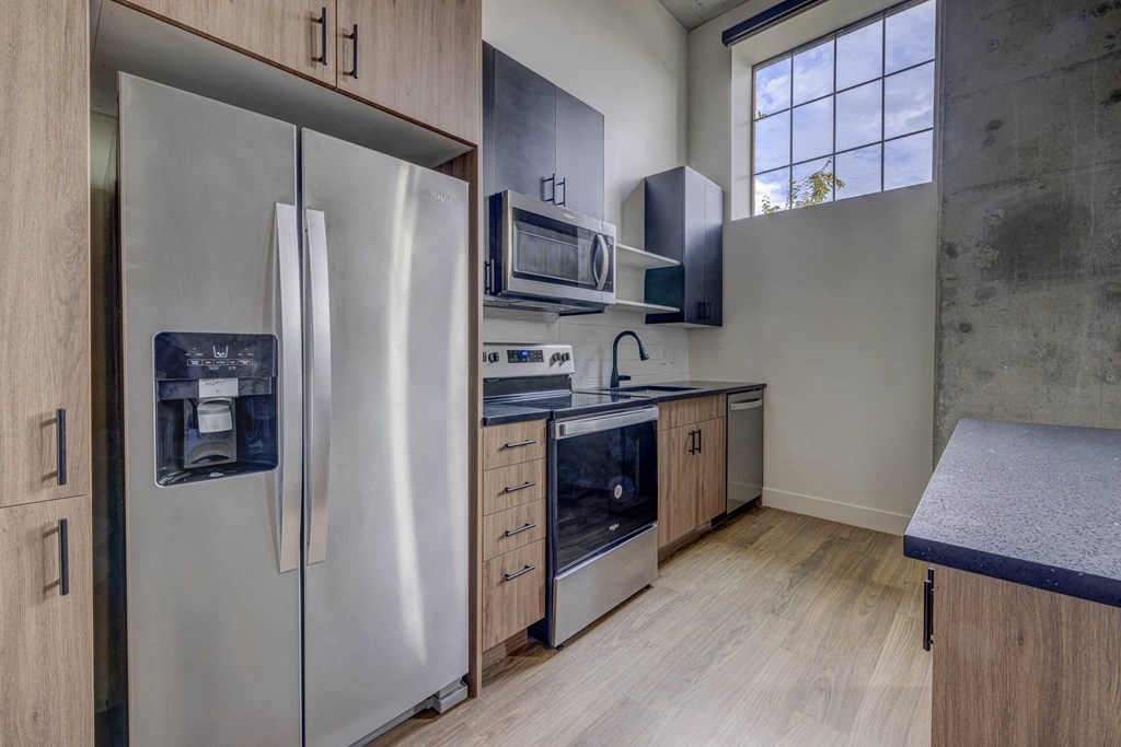a kitchen with stainless steel appliances and wooden cabinets