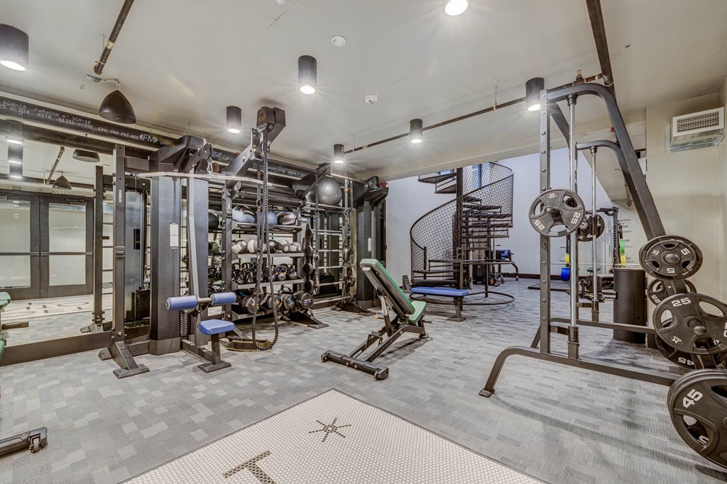 a gym with weights and other equipment in a building with