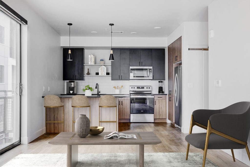 a living room with a kitchen and a table