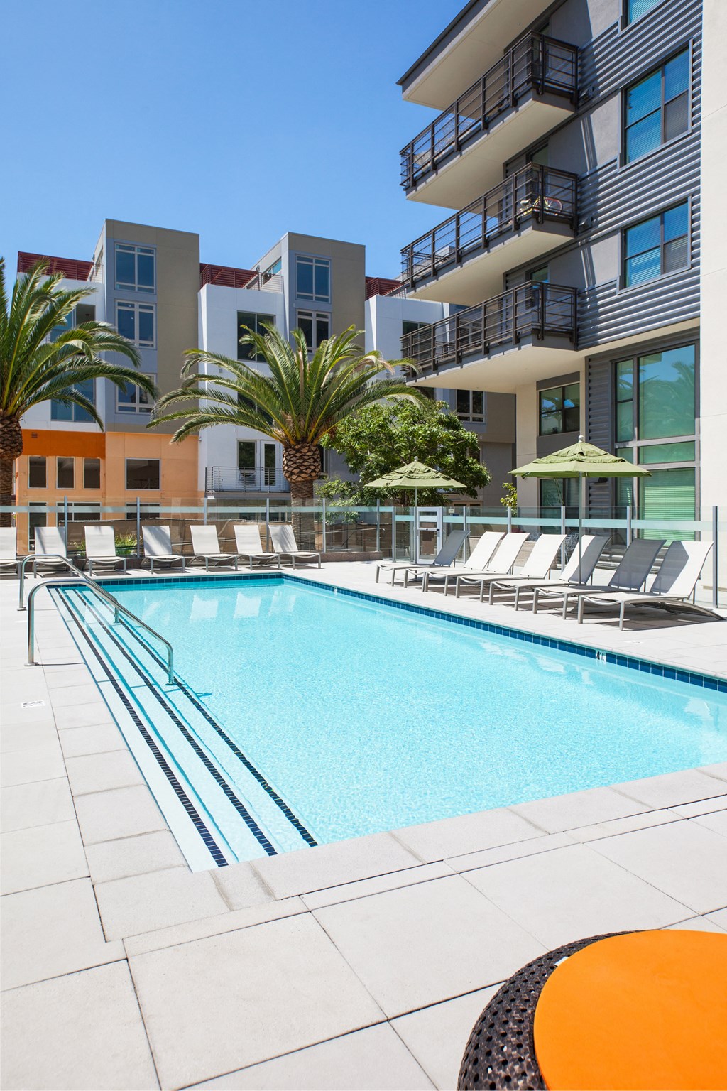 outdoor pool with lounge chairs and exterior of building