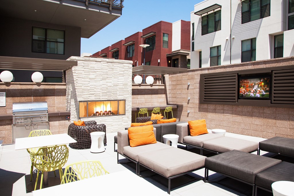 a patio with couches and chairs and a fireplace