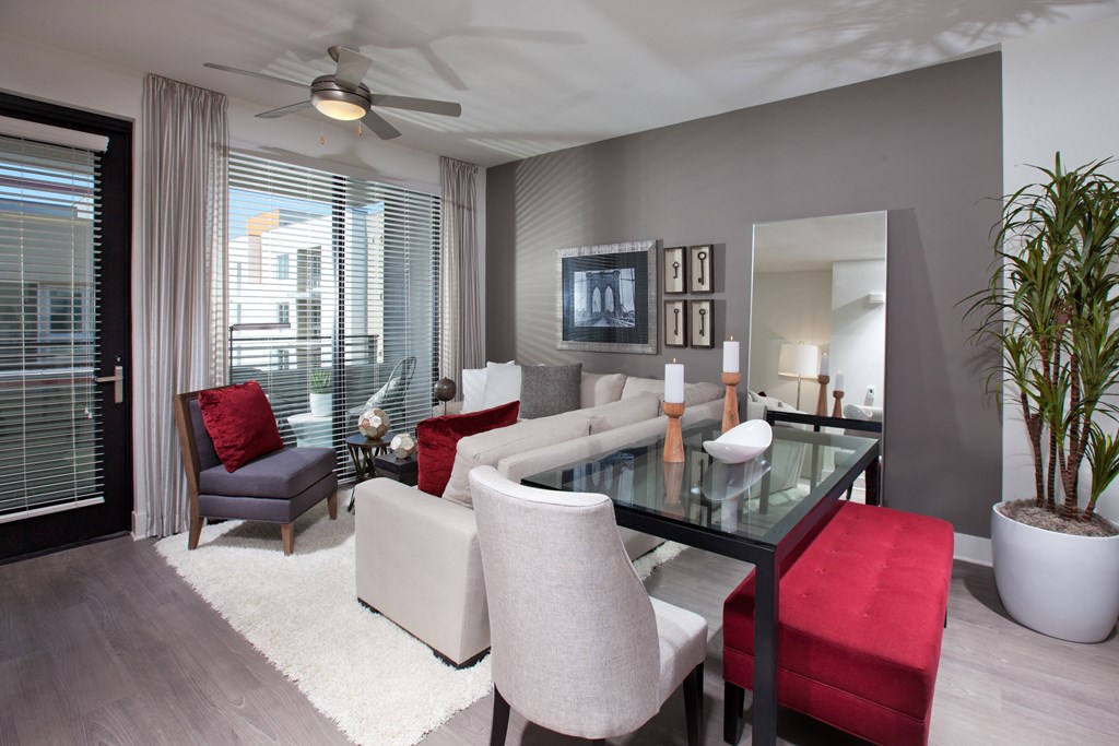 a living room filled with furniture and a large window