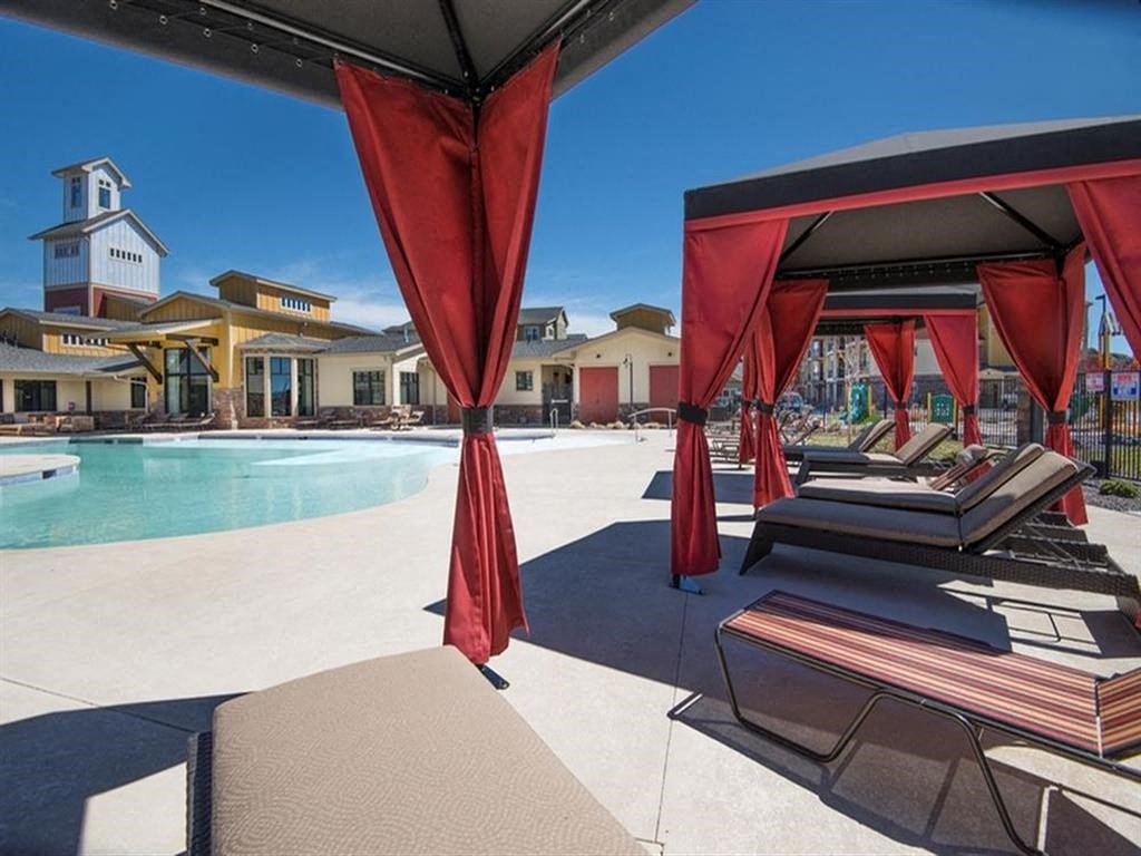 lounge chair seating under cabana near pool
