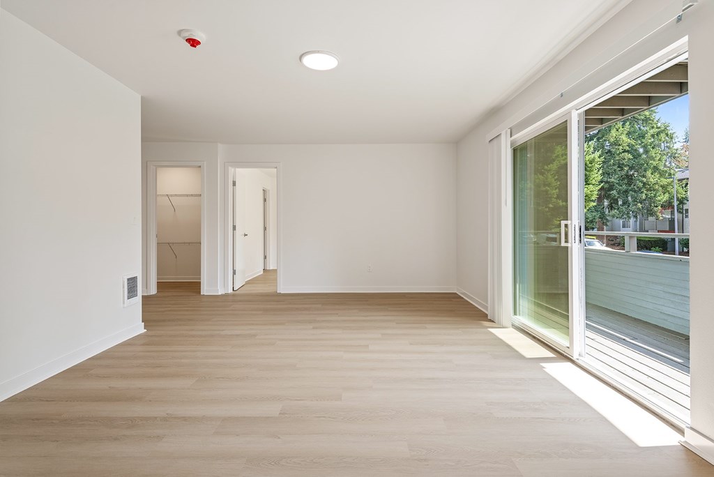 A room with a white ceiling and wooden floor.