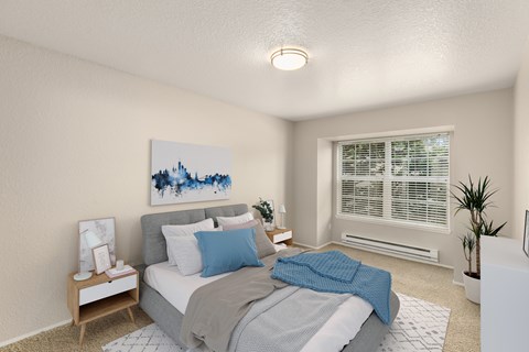 A bedroom with a bed, nightstand, and a painting on the wall.