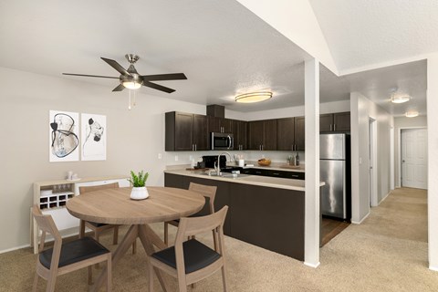 A modern kitchen with a dining table and chairs.