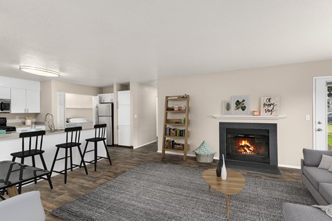 A living room with a fireplace and a dining area in the background.