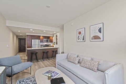 A living room with a grey couch and a coffee table.