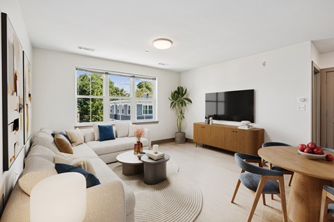 A modern living room with a large window and a flat screen TV.