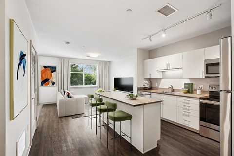 A modern kitchen with white cabinets and a large island.
