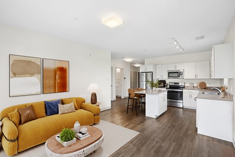 A modern living room with a yellow couch and a coffee table.