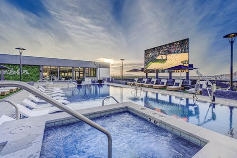 a swimming pool with lounge chairs and a movie screen at the resort at governors crossing