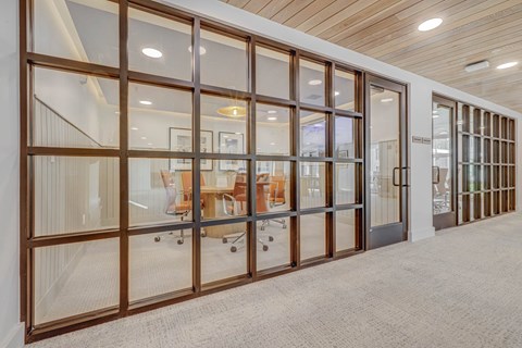 a conference room with glass doors and a table in the middle