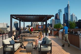 a roof deck with a view of the chicago skyline