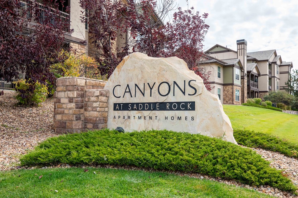 the sign in front of the canyon at saddle rock apartments