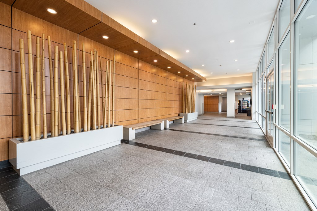 A long hallway with a row of wooden slats on the wall.