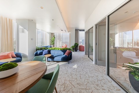 A modern living room with a wooden table and blue sofa.