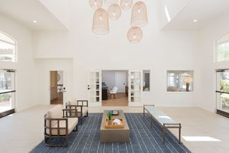 a living room filled with furniture and a large chandelier