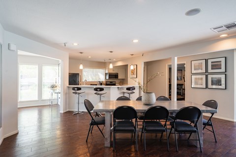 A dining room with a table set for six.
