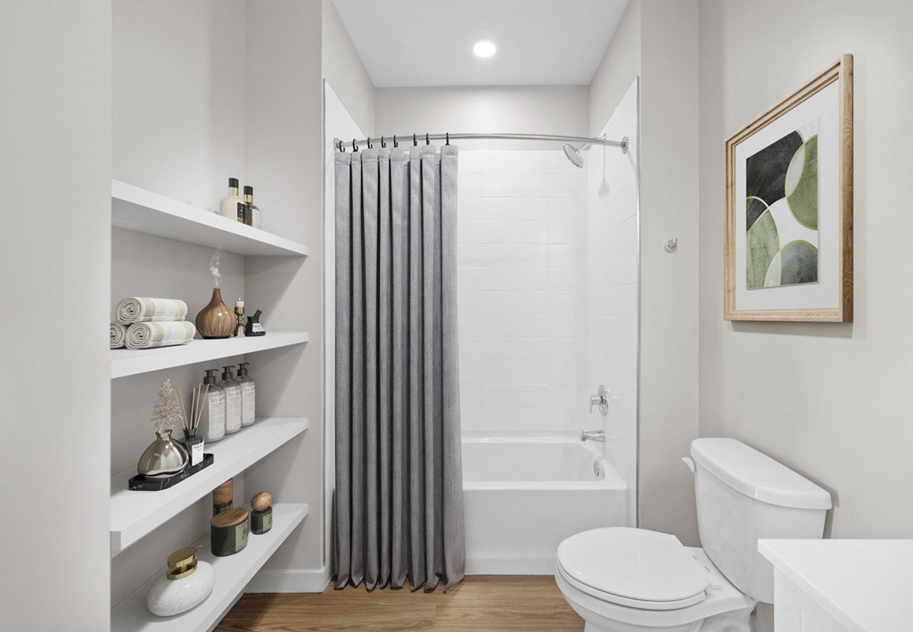 a white bathroom with a shower and a toilet and shelves