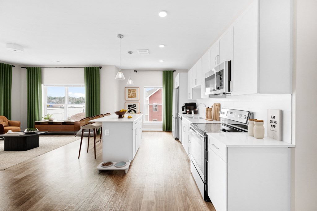 a kitchen and living room with white appliances and a large window