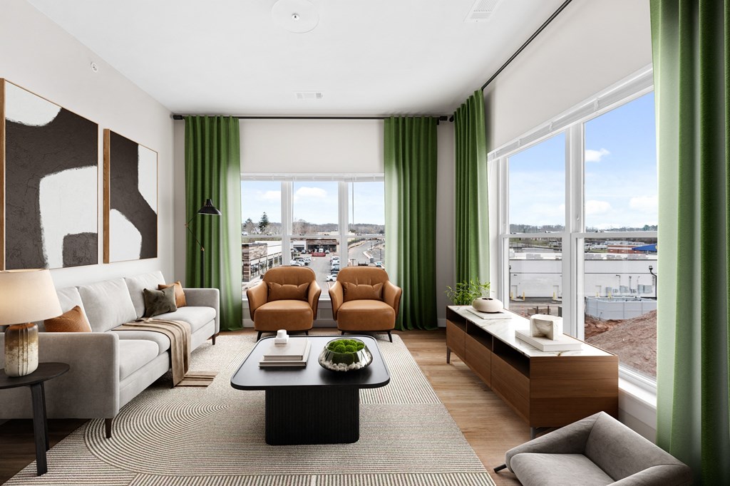 a living room with green curtains and white and brown furniture and large windows