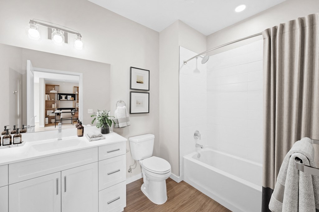 a white bathroom with a shower toilet and sink