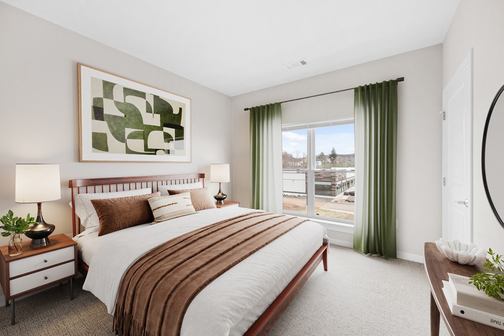 a bedroom with a large bed and a window