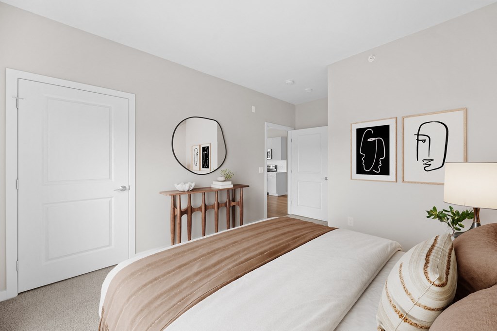 a bedroom with a large bed and a mirror on the wall