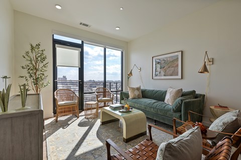 A living room with a green couch and a wooden coffee table.