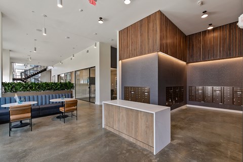A reception area with a wooden reception desk and chairs.