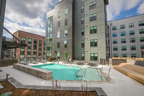 A large building with a pool in front.
