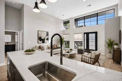 A modern kitchen with a marble countertop and a large island.