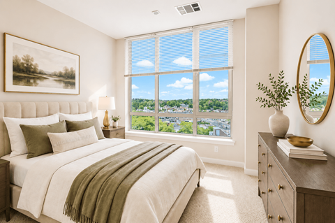 A bedroom with a large bed and a view of the city through the window.