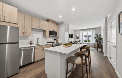 A modern kitchen with wooden cabinets and stainless steel appliances.