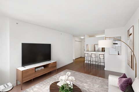 A living room with a television and a staircase.