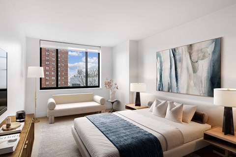 a bedroom with a bed and a large window