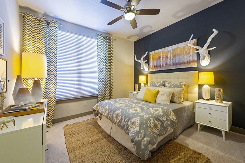 a bedroom with a large bed and a ceiling fan
