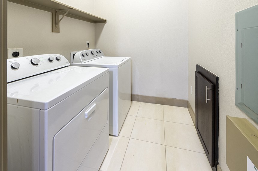 a washer and dryer in a laundry room with a door